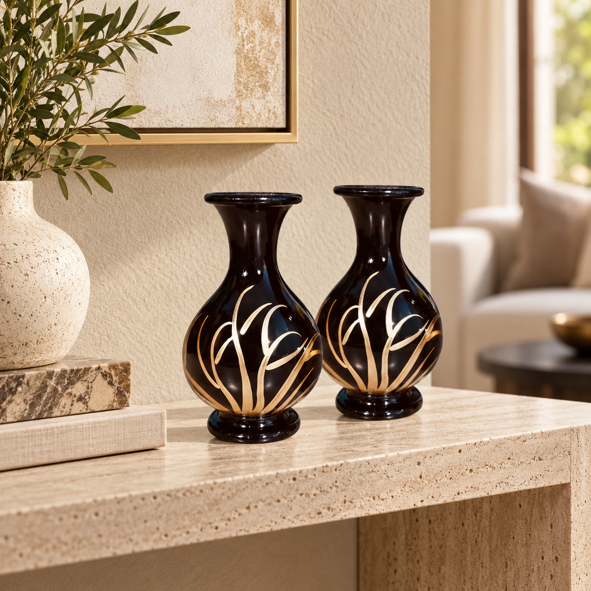 Noir Bloom black and gold vase pair styled on a travertine console