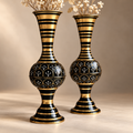 Close detail of the Aurelia black and gold iron floor vase set and painted floral motifs