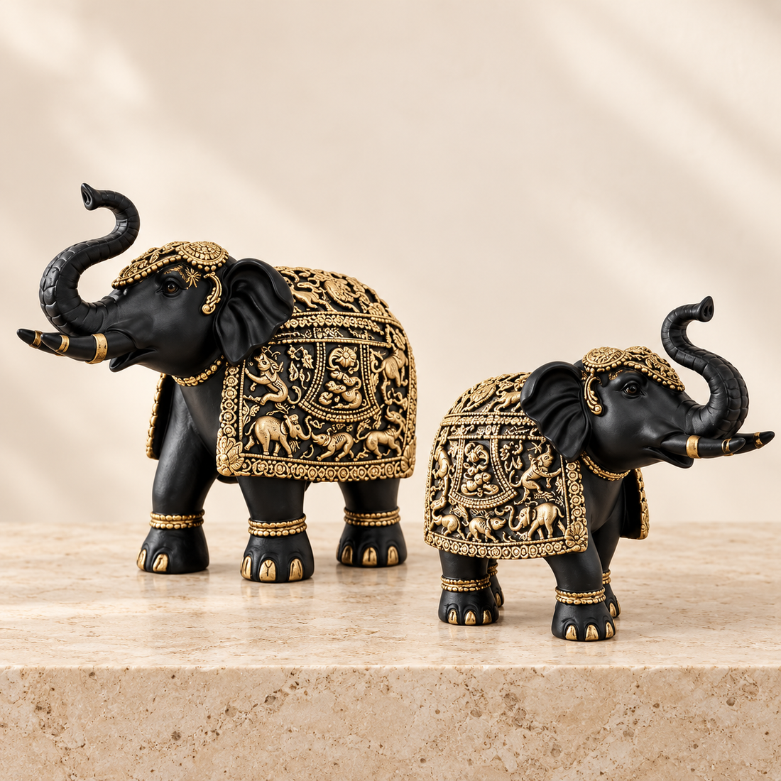 Aurum Gaja black and antique gold raised-trunk elephant sculpture set of two