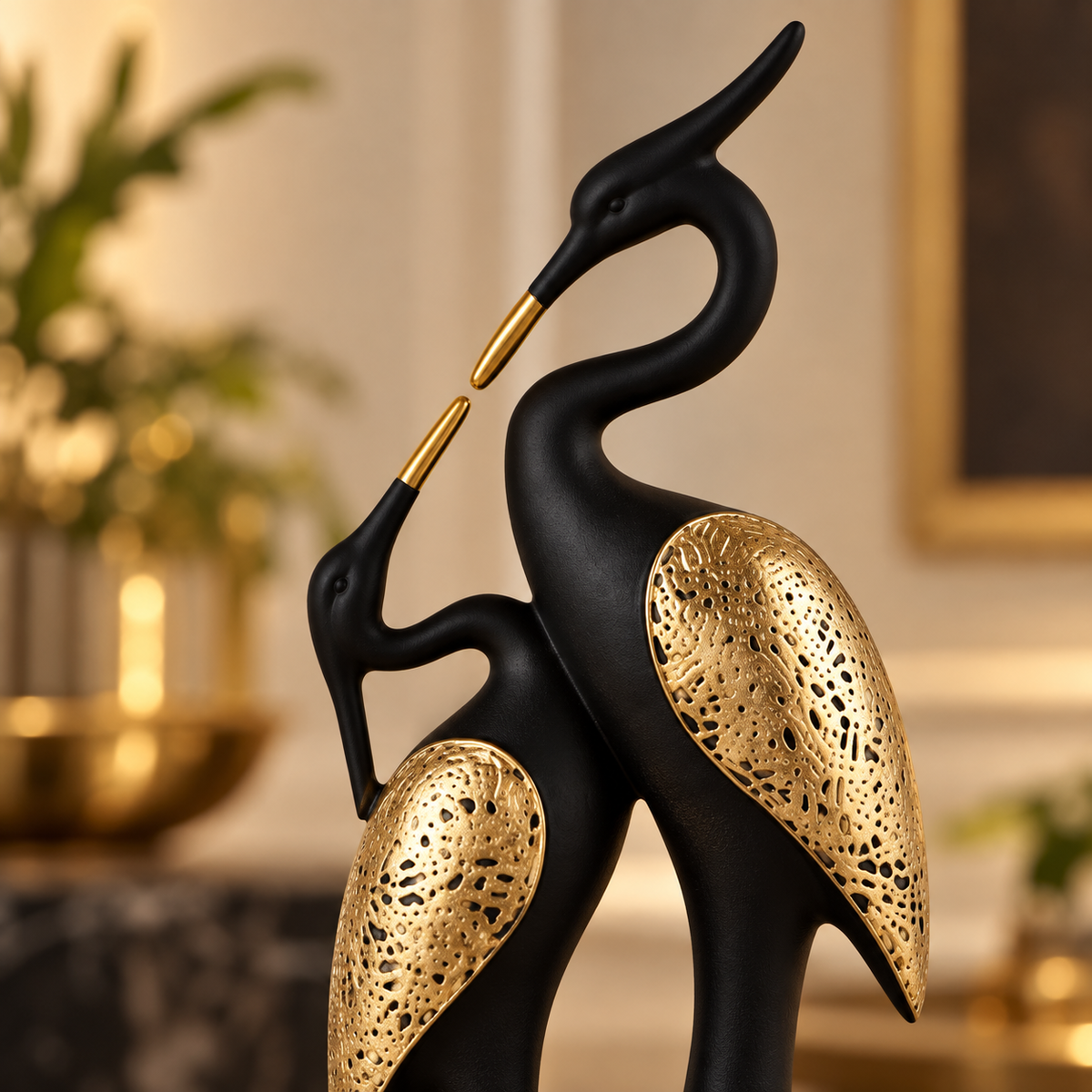 Close-up of Eternal Grace crane couple sculpture with matte black finish and gold filigree wings