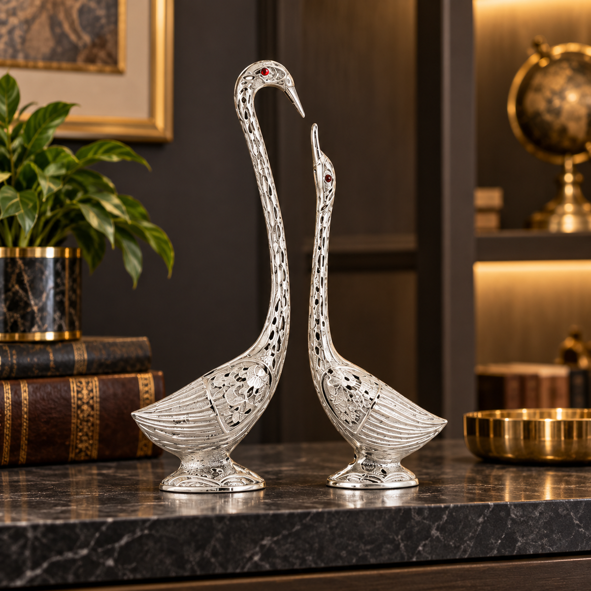 Oxidised silver swan figurines in a premium office interior