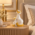 White and gold cat figurine pair displayed on a luxury bedside table