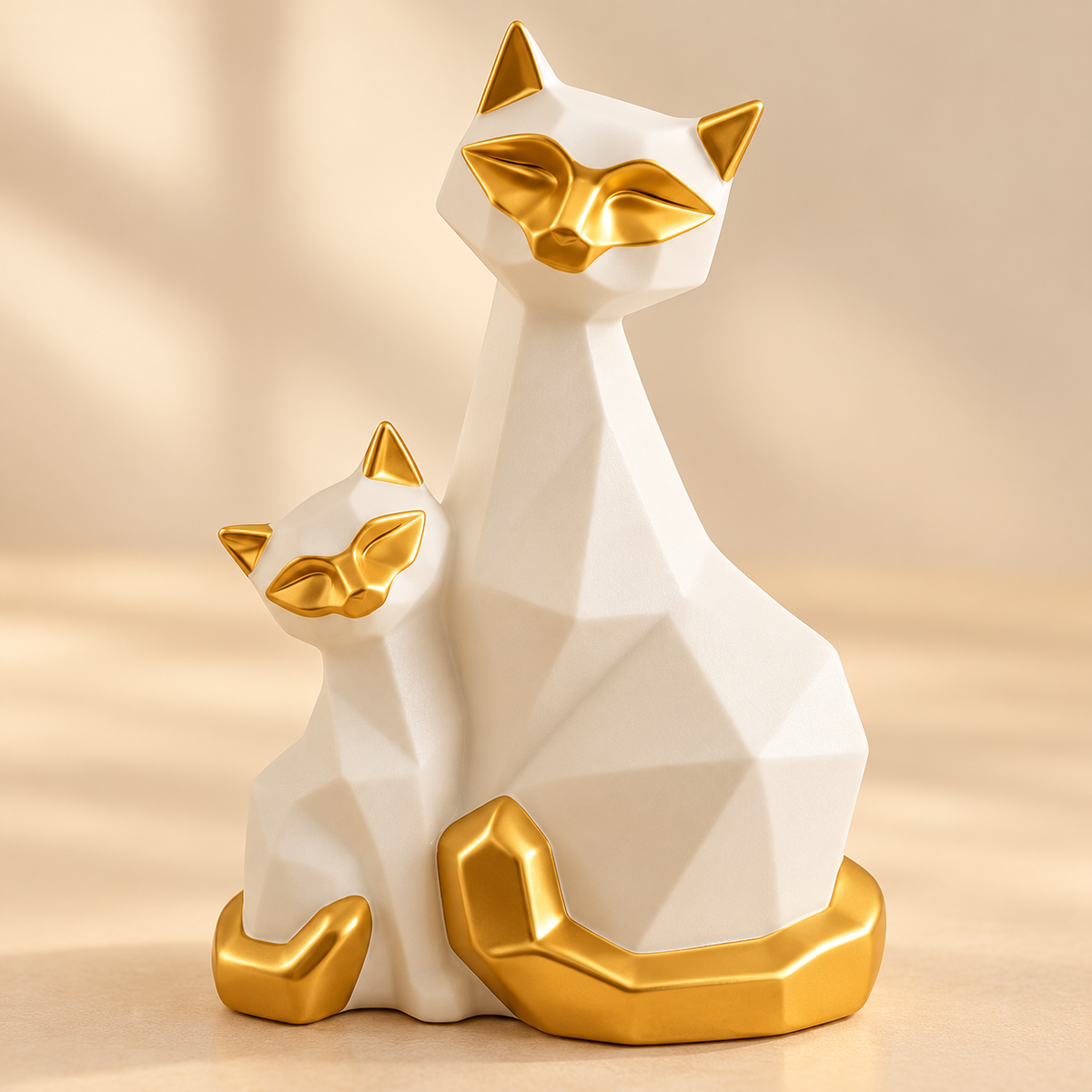Close-up of matte white porcelain and golden detailing on geometric cat figurines