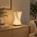 Helix Glow off-white ambient table lamp styled on a light oak living-room console