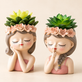 Quiet Muse resin woman bust planter set of two with green succulents on warm ivory