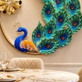 Close-up of peacock body and decorative metalwork on wall art
