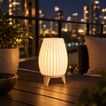Ribbed table lamp glowing on a high-rise balcony