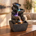 Serenity Cascade LED tabletop fountain styled on a premium living room console
