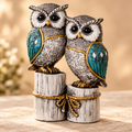 Close detail of engraved silver owl bodies, teal wings and antique-gold accents