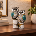 Decorative Wise Companions owl couple displayed on a warm walnut study shelf